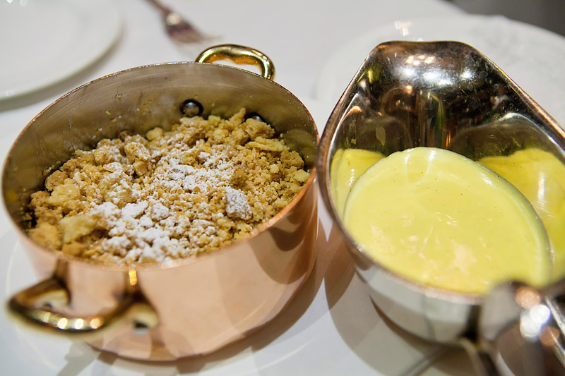 Apple & sultana crumble served with custard at Rules